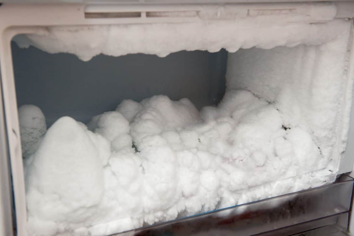 An un-defrosted freezer with thick ice building up inside, How Long Does A Freezer Defrost Cycle Last?