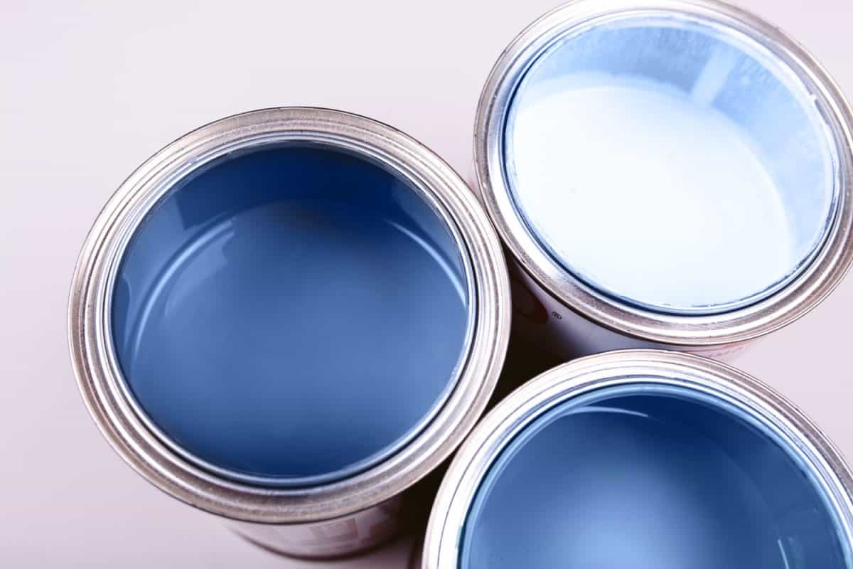 Blue and white colored paint on a white background
