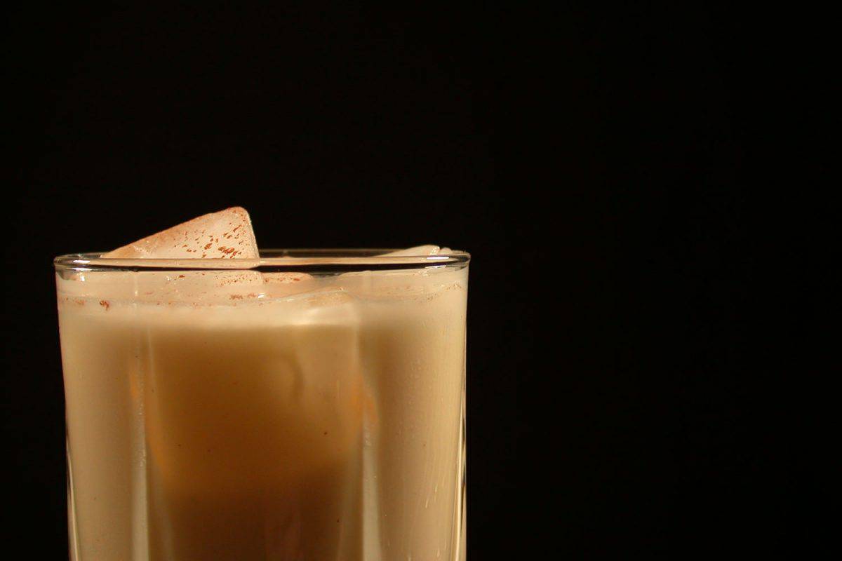 A delicious glass of eggnog and ice cubes