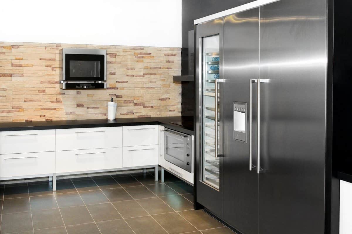 A huge two door fridge inside a modern kitchen, Should You Defrost Fridge Before Moving?
