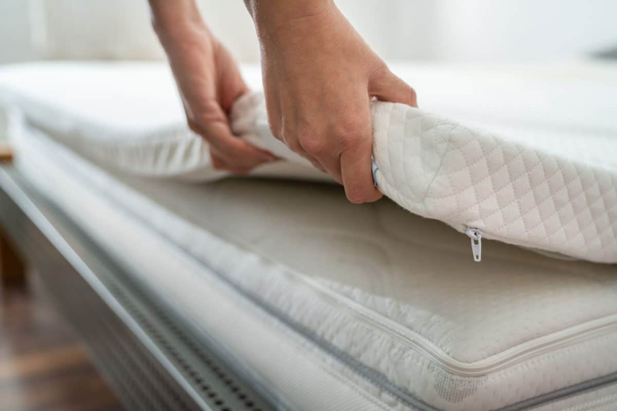 A woman removing the mattress and checking for bed bugs