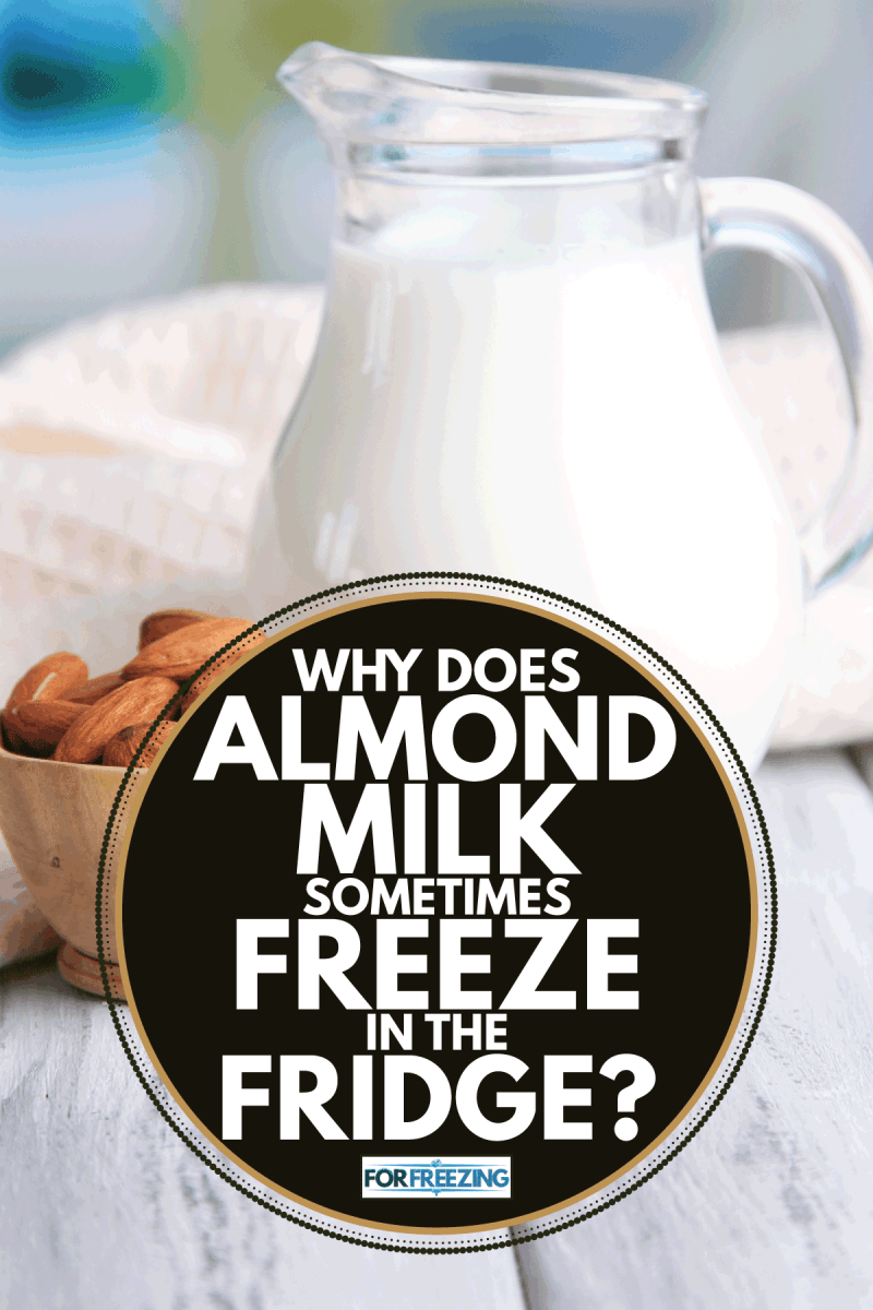 Almond milk in jug with almonds in bowl, on color wooden table, on bright background. Why Does Almond Milk Sometimes Freeze In The Fridge
