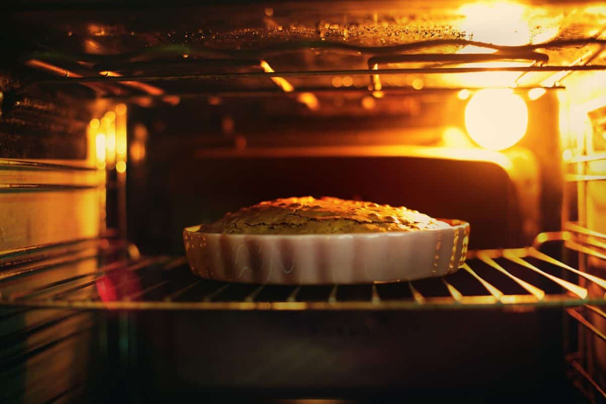 apple pie being reheated in an oven