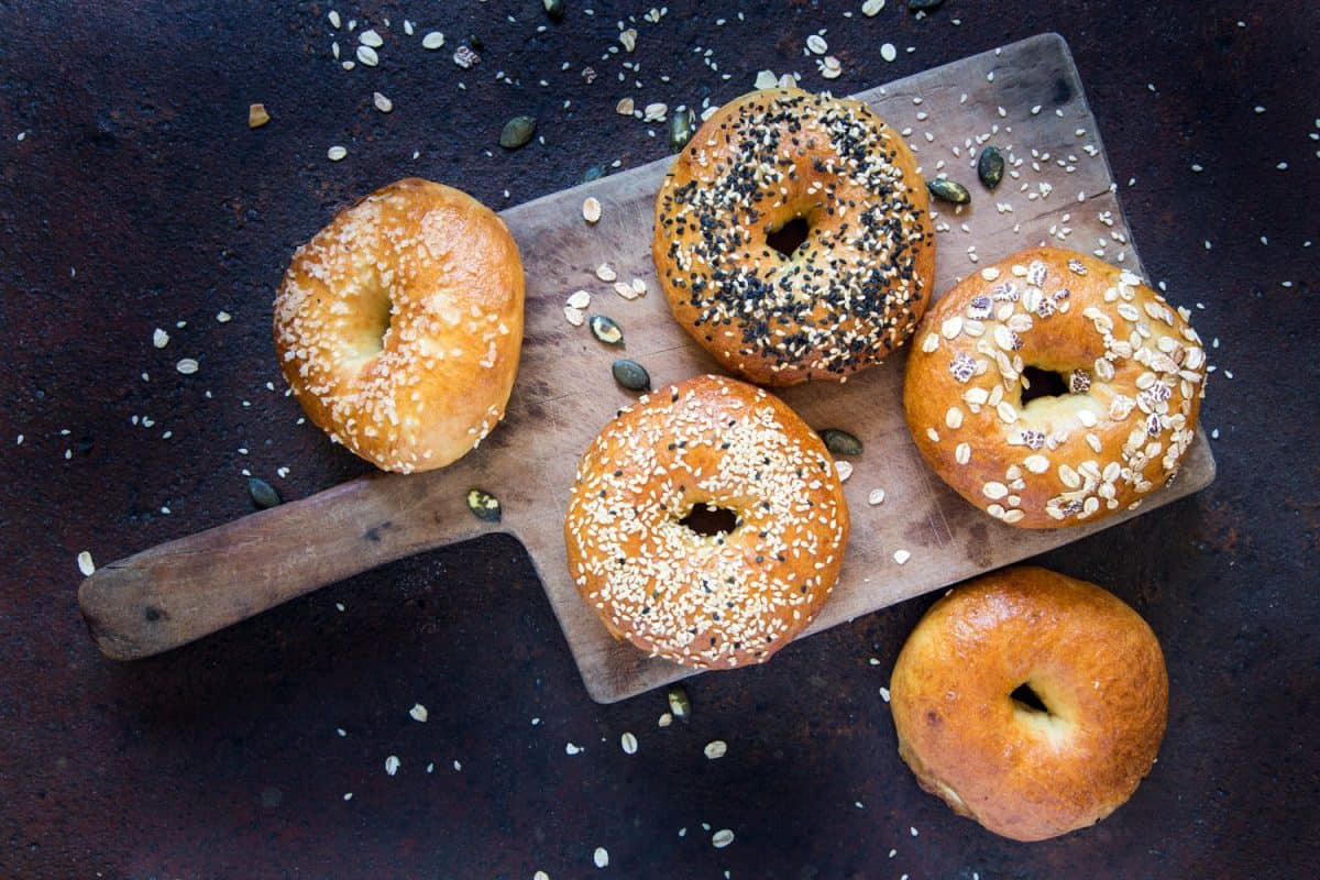 Five pieces of bagels with different kinds of toppings