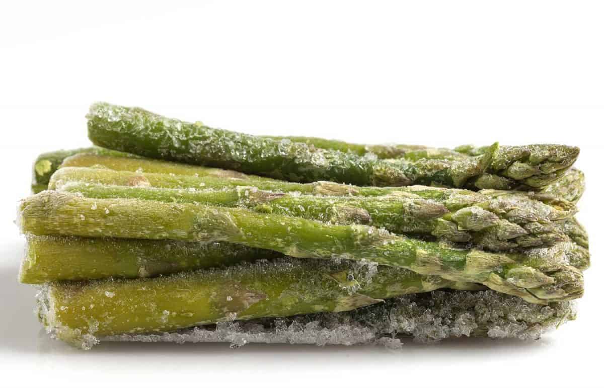 Frozen asparagus on white background