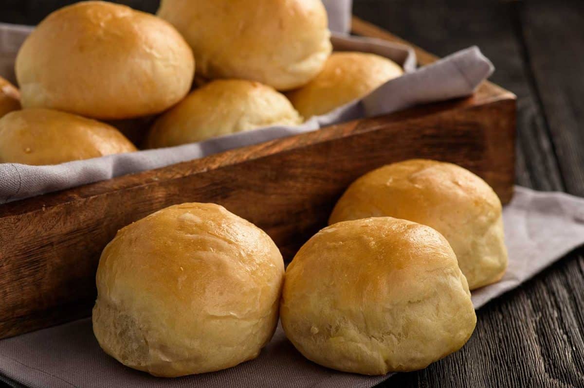 Homemade potato bread rolls on wooden tray