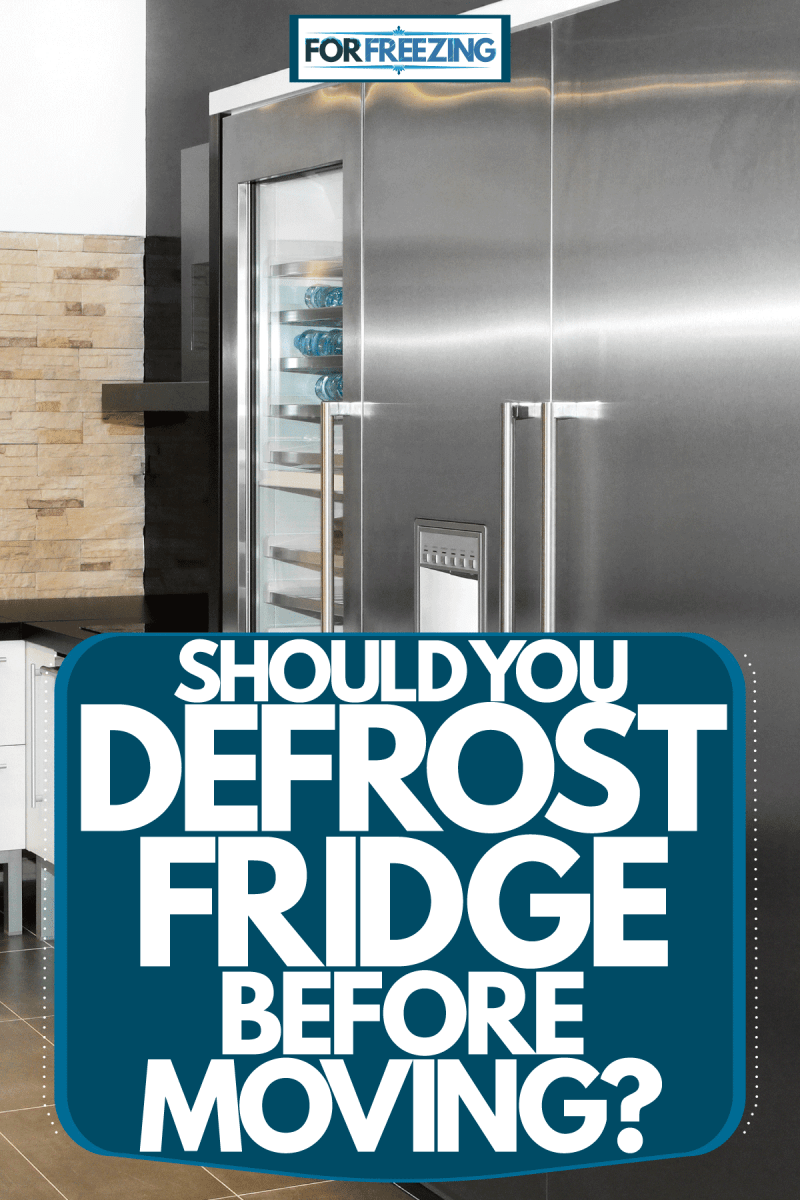A huge two door fridge inside a modern kitchen, Should You Defrost Fridge Before Moving?