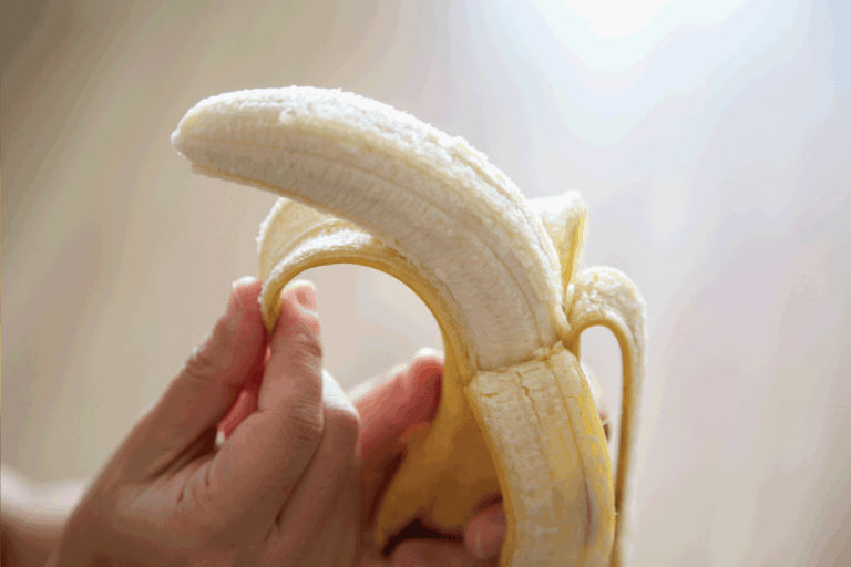 hand peeling banana, Should You Freeze Bananas Peeled Or Unpeeled