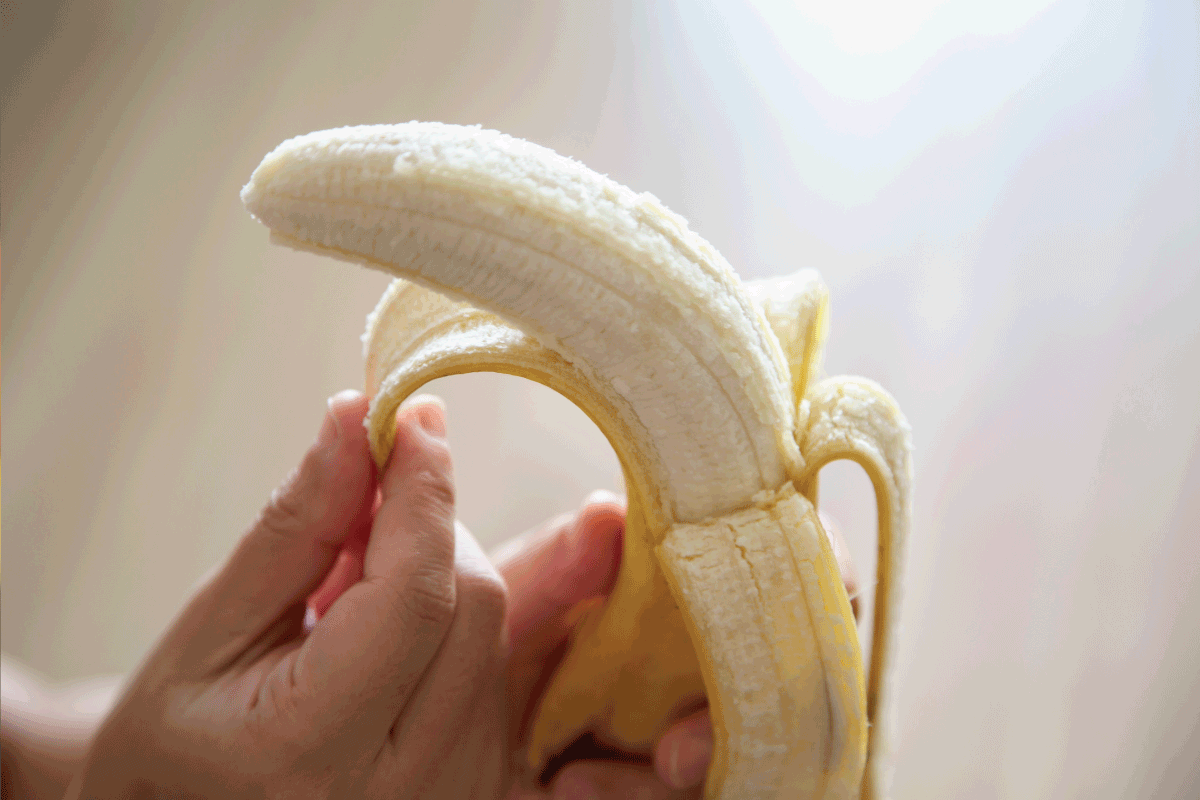 hand peeling banana, Should You Freeze Bananas Peeled Or Unpeeled