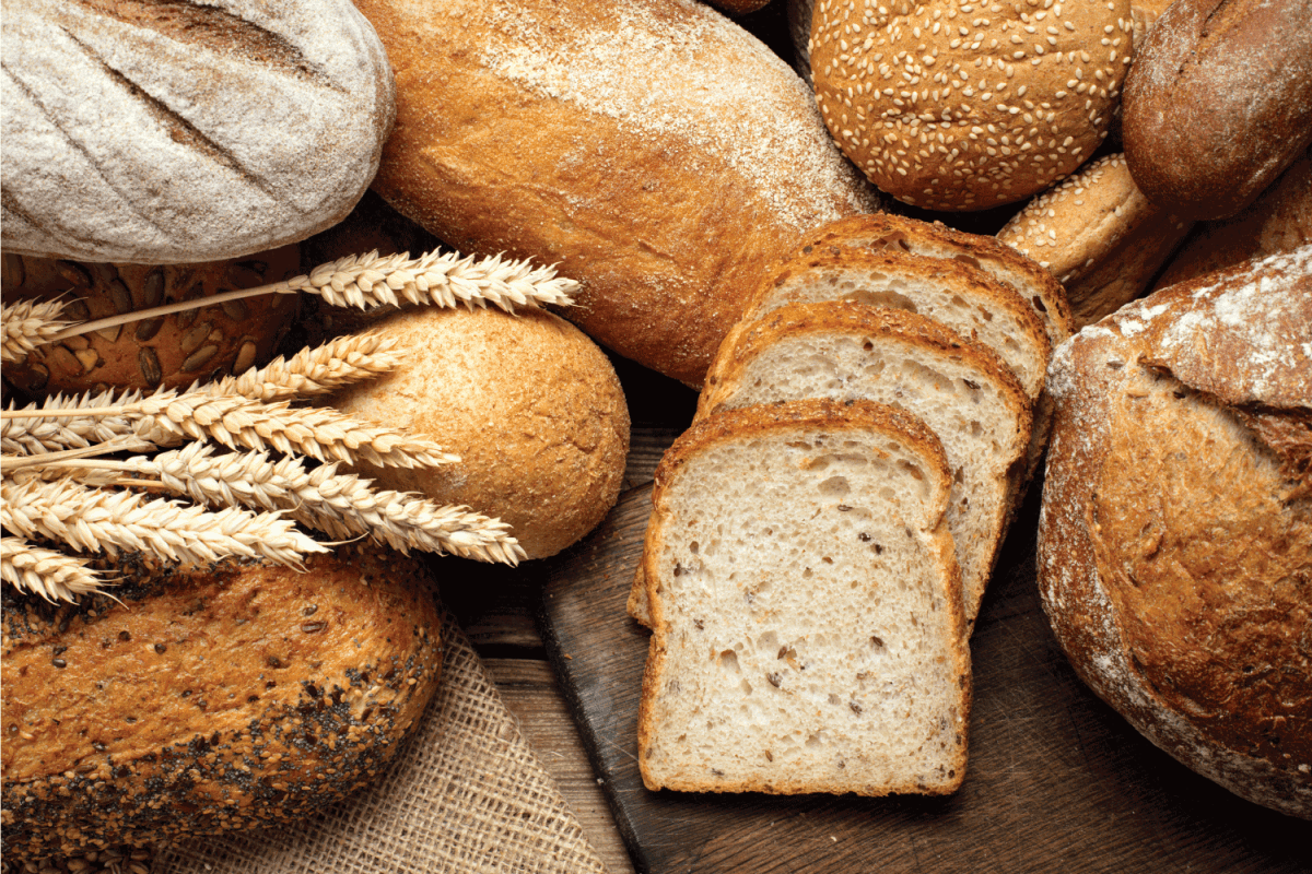 heap of various bread on wooden background