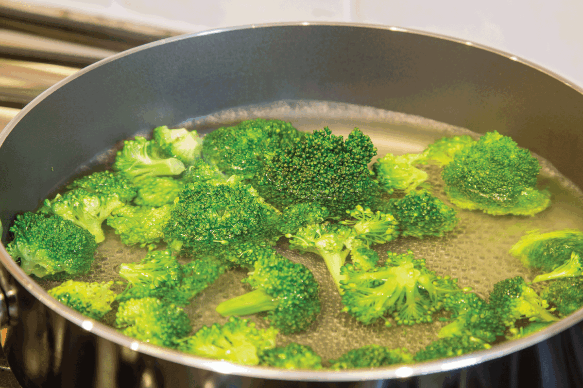 Blanching the broccoli to a bright green in boiling water