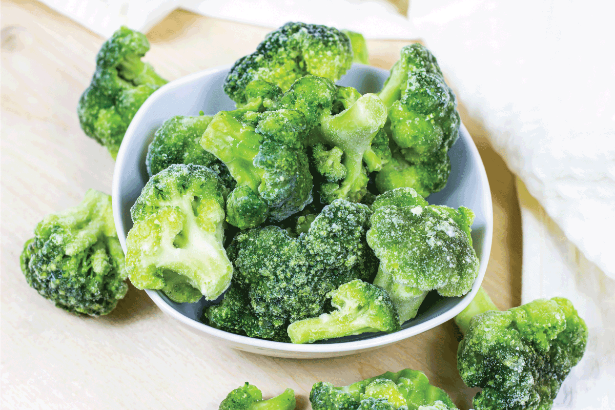 Fresh green frozen broccoli in small white bowl on light background. How To Freeze Fresh Broccoli