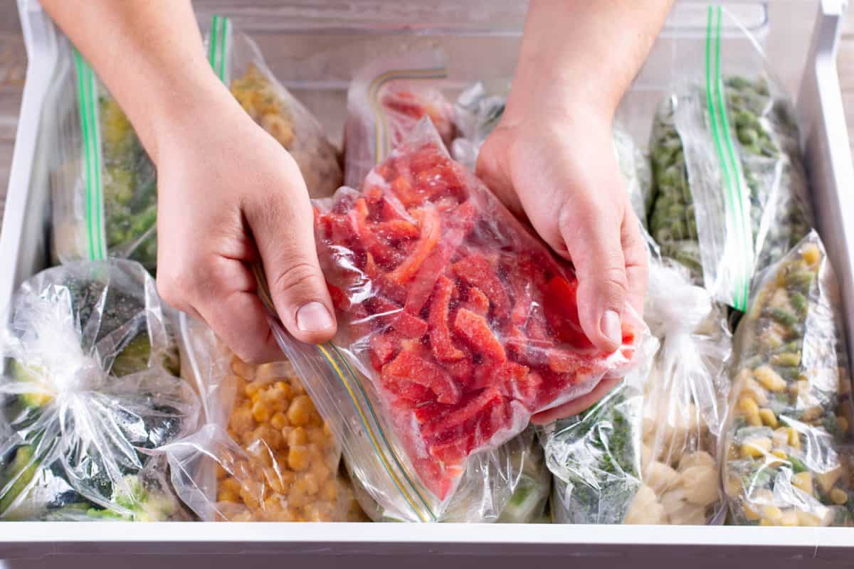 Frozen red peppers. Frozen vegetables in a plastic bag in freezer

