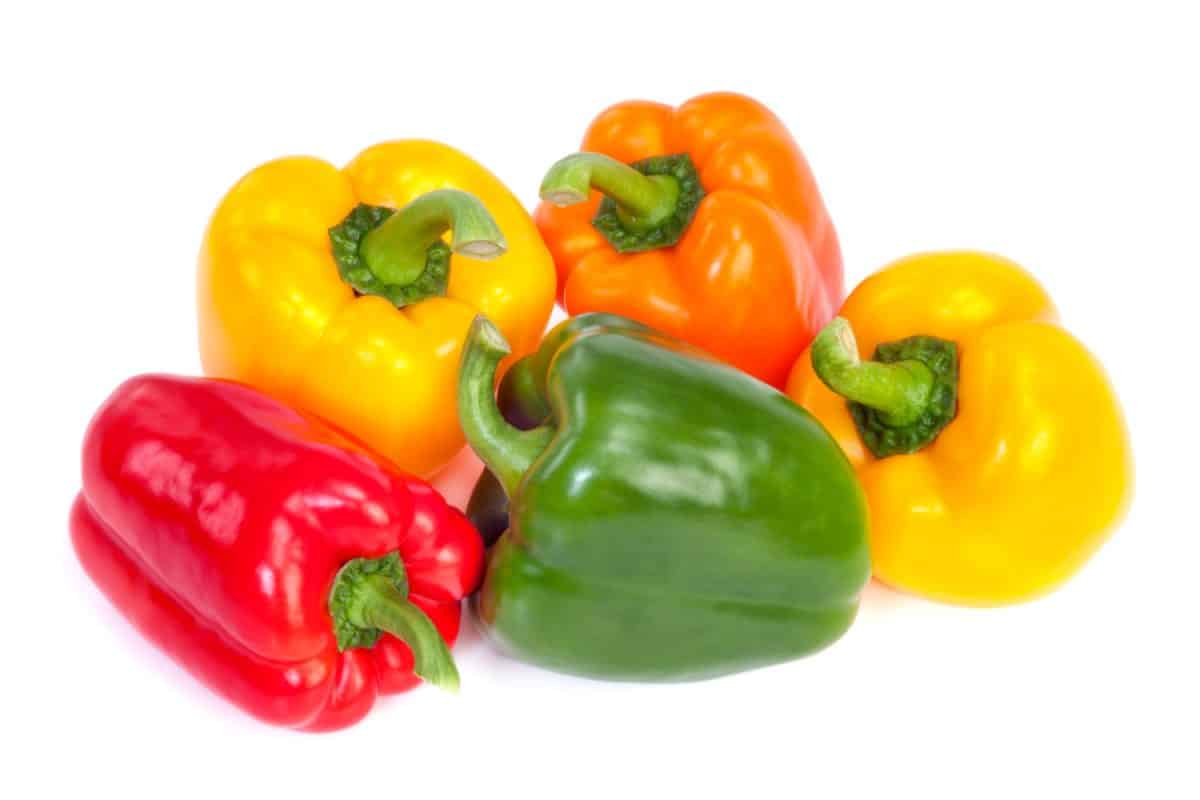 Group of bell peppers isolated on white background. Green, yellow, red and orange colors.

