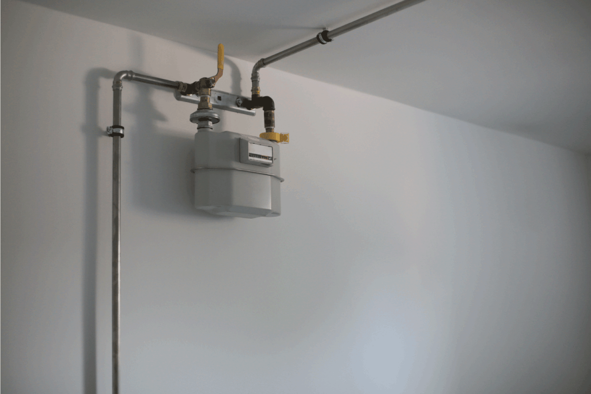 Natural Gas pipes and meter on white wall in house