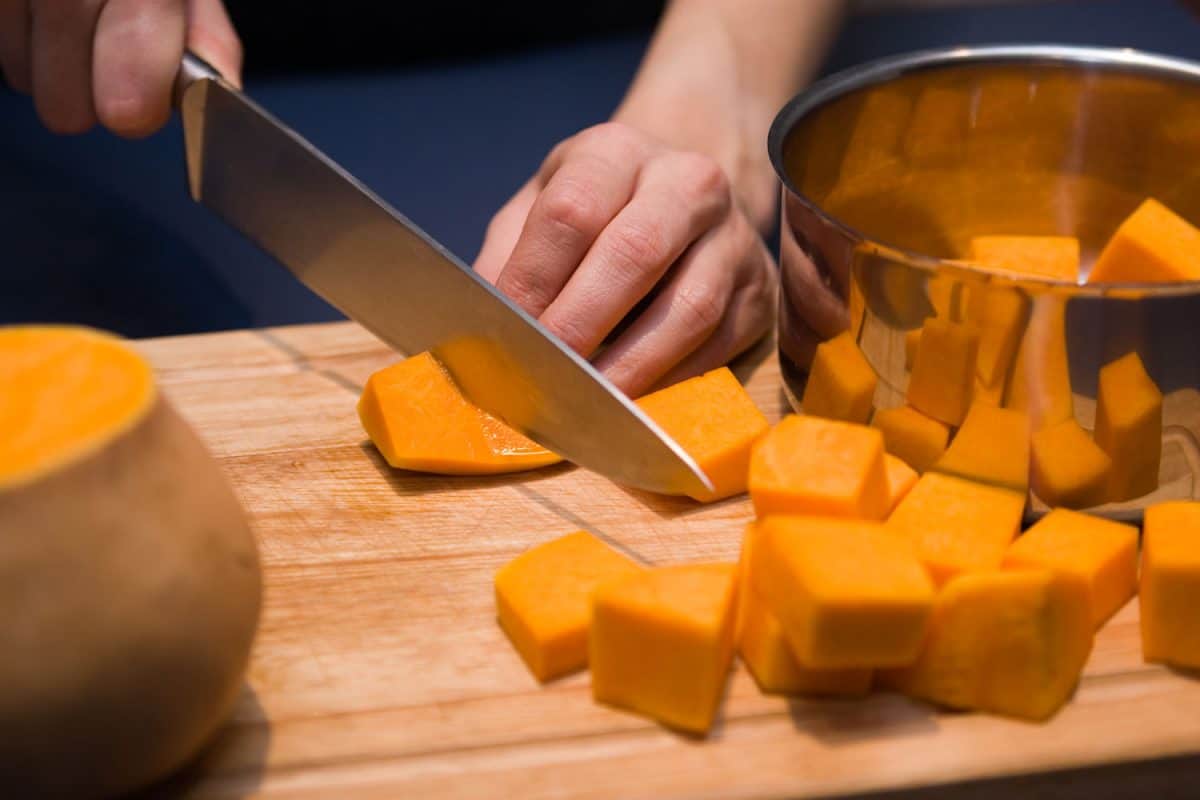 Preparing cubes of pumpkin for cooking