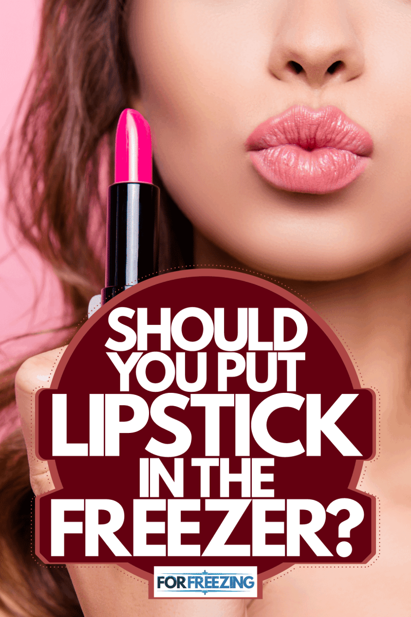 A woman applying lipstick on her lips on a pink background, Should You Put Lipstick In The Freezer?