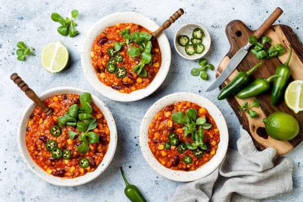 Vegetarian chili con carne with lentils, beans, lime, jalapeno. Mexican traditional dish