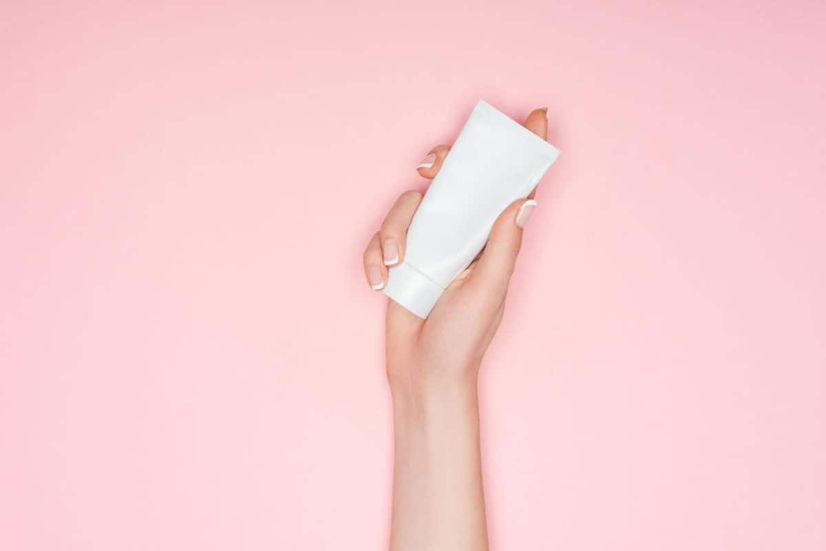 cropped view of woman holding hand cream isolated on pink with copy space, Can Hand Lotion Freeze?