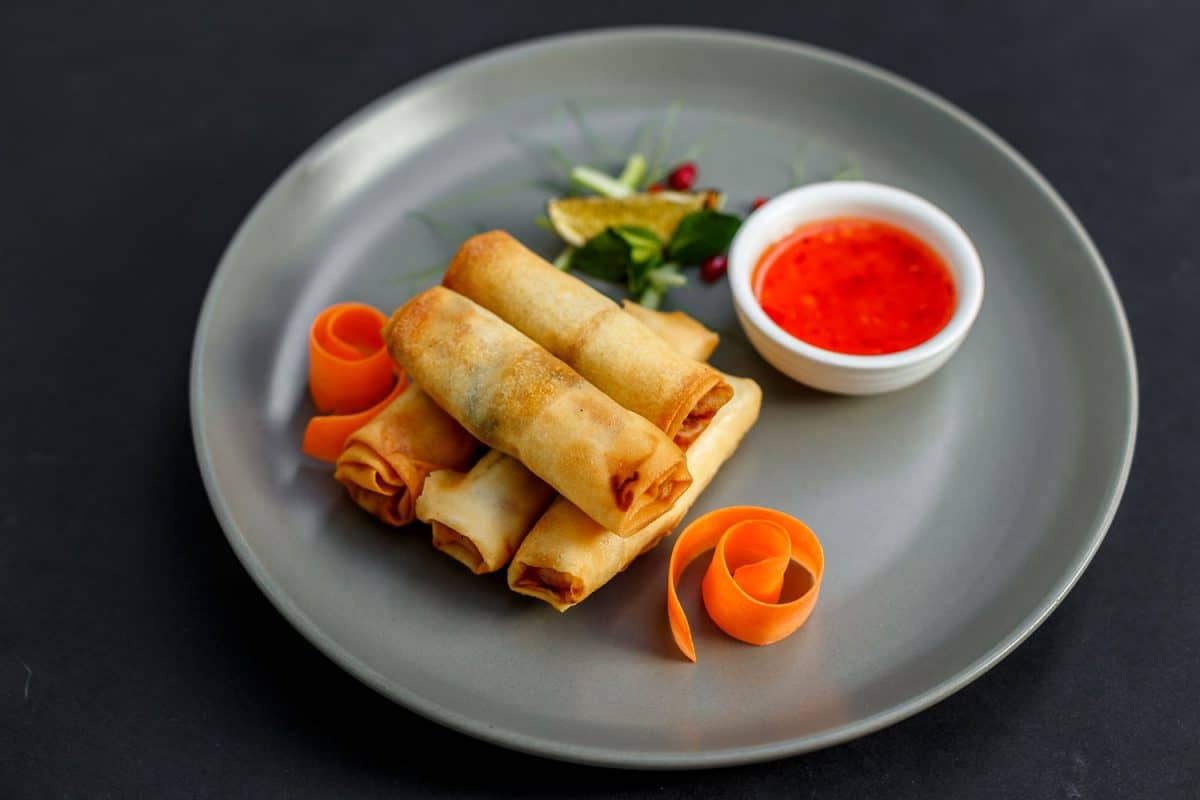 Egg rolls with small carrot slices and sauce on the side, How To Thaw Egg Roll Wrappers