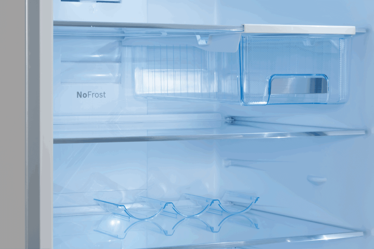 a clean blue interior of a home freezer with no frost. How To Fix A Cracked Freezer Drawer