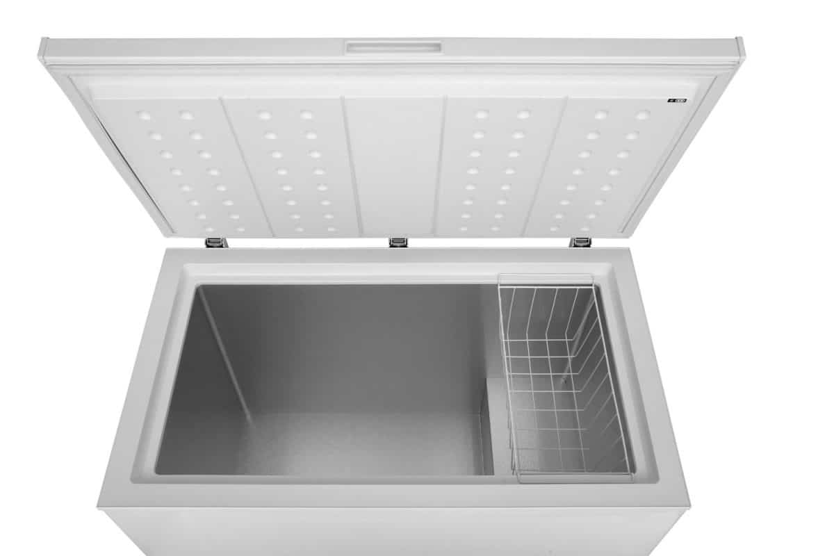 An opened chest freezer on a white background