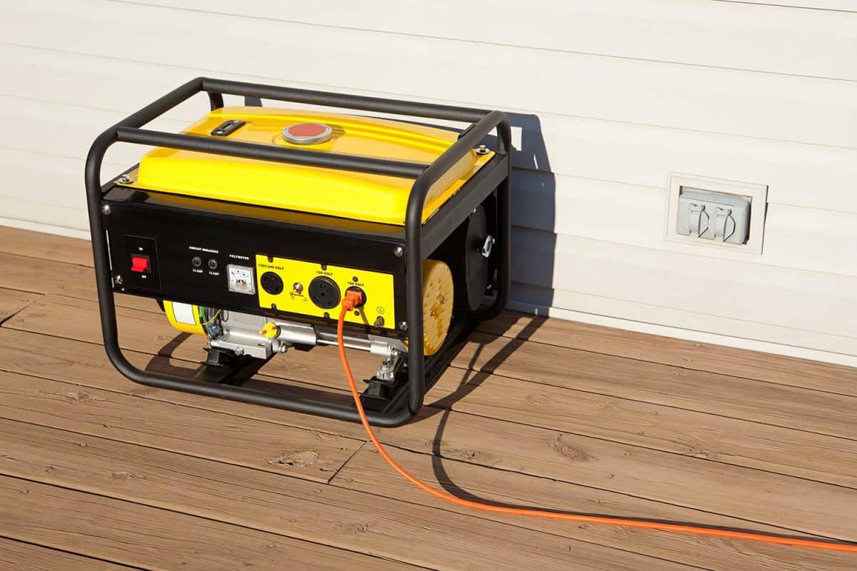 Extension cord plugged into a gasoline powered portable electric generator