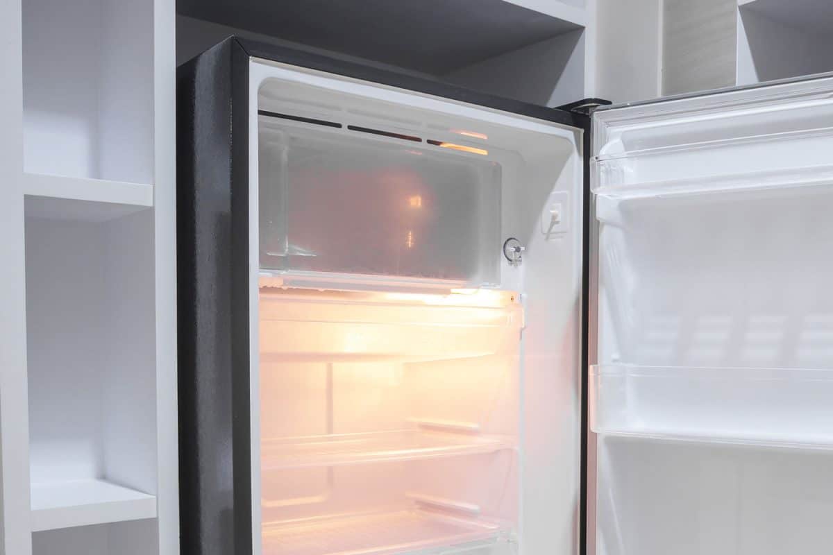 An empty refrigerator with its freezer door left open, Can't Open Freezer Door - What To Do?