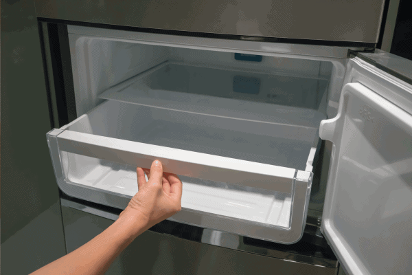 Woman hand open plastic white container drawer in new refrigerator. How To Put A Freezer Drawer Back In [Inc. For Specific Brands]