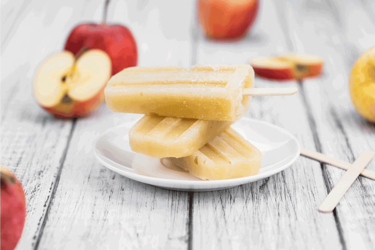 popsicles made of applesauce on a wooden picnic table