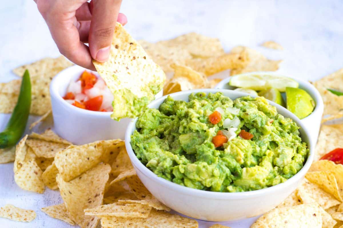 Fresh guacamole with hand dipping