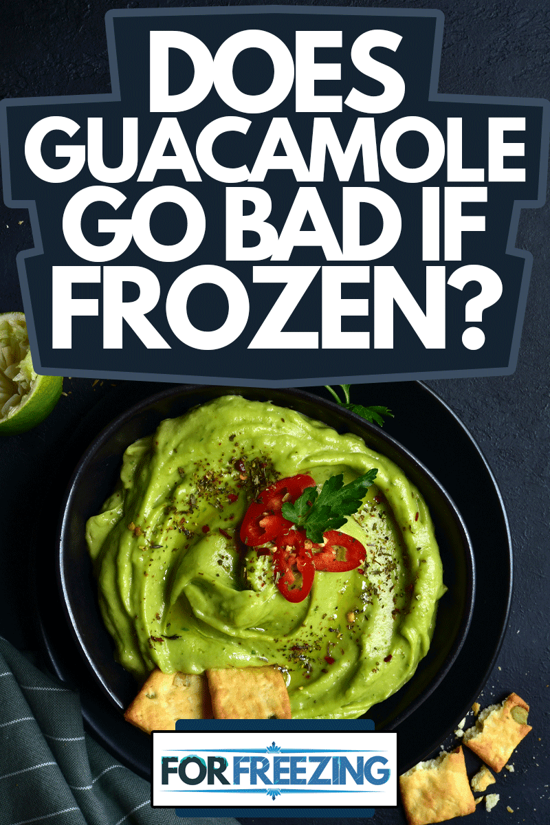 Guacamole - traditional mexican spicy avocado dip in a black bowl on a dark slate, stone or concrete background, Does Guacamole Go Bad If Frozen?
