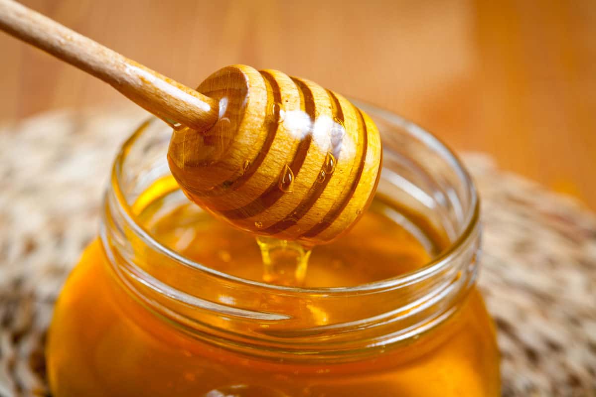 A pot of honey in a bottle of jar