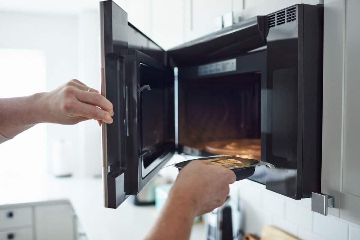 Unrecognizable male putting food into a microwave, How To Thaw Nutrisystem Snacks