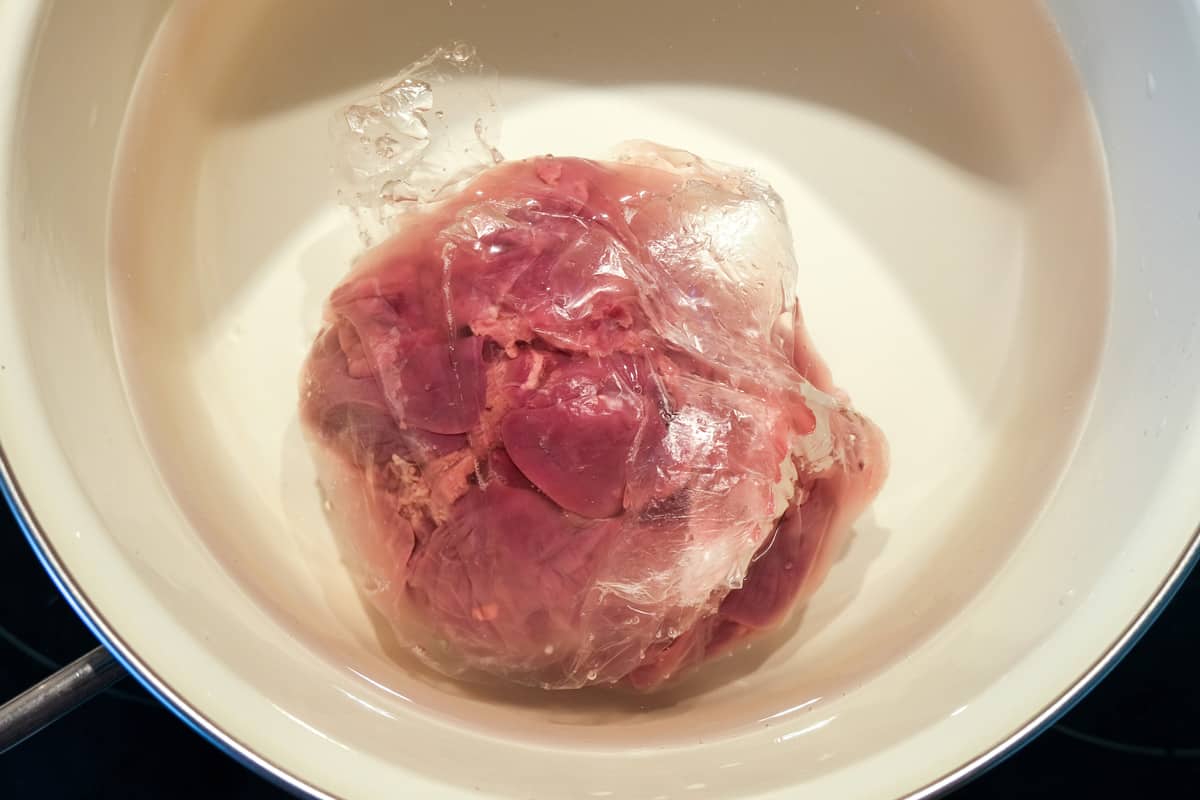 Defrosting meat in water.