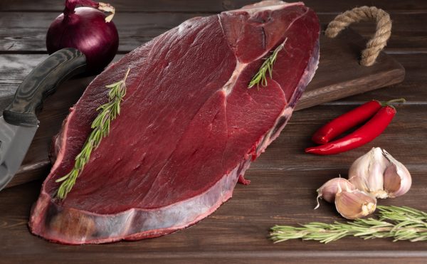 piece of fresh raw meat on a wooden background. meat, rosemary and spices. Moose meat is considered one of the most low-calorie and useful for the human body. most dietary meat, healthy food., How To Thaw Moose Meat