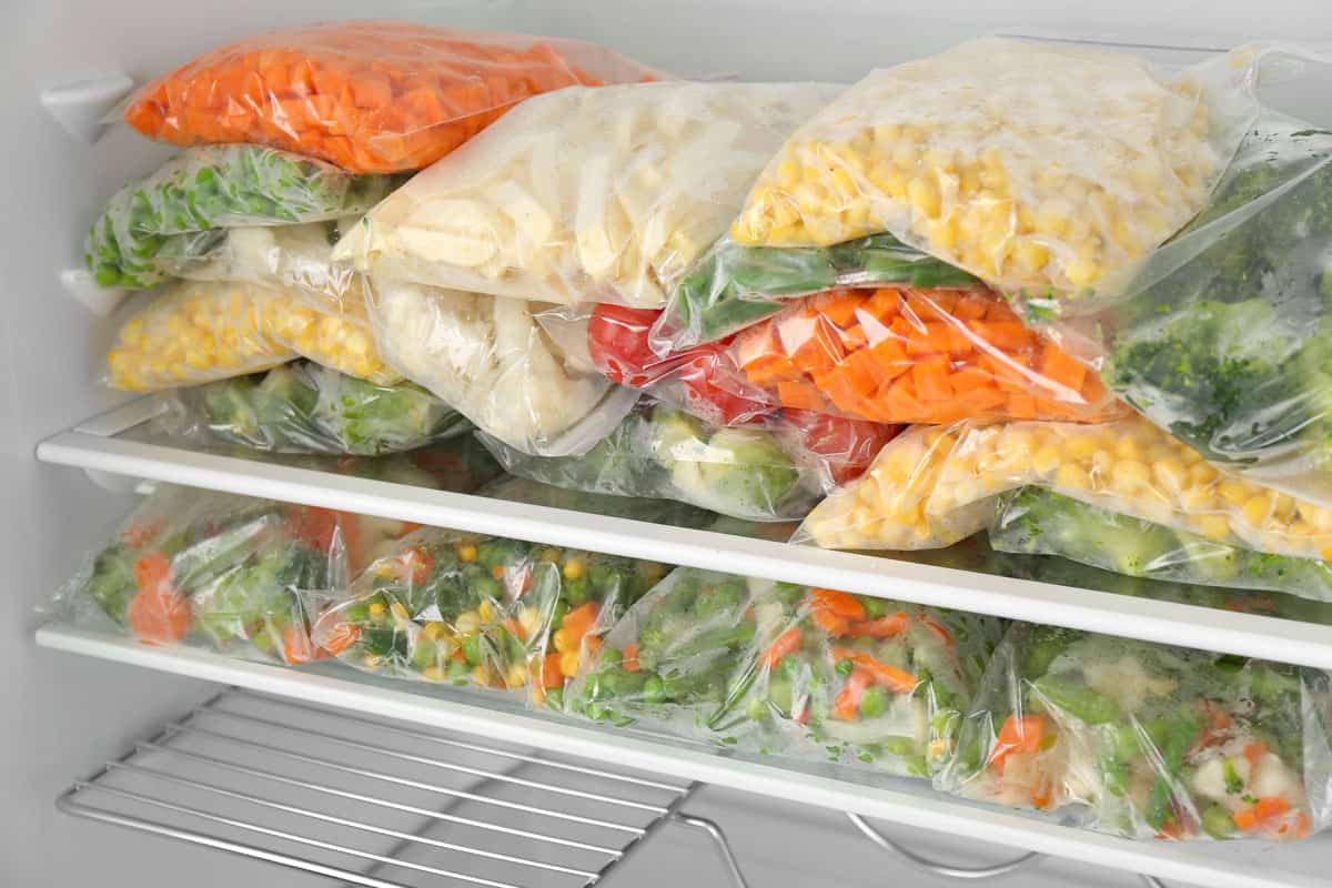 An assortment of veggies in sealed bags inside the freezer