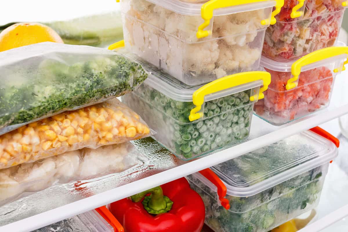 Frozen food in the refrigerator. Vegetables on the freezer shelves. Stocks of meal for the winter